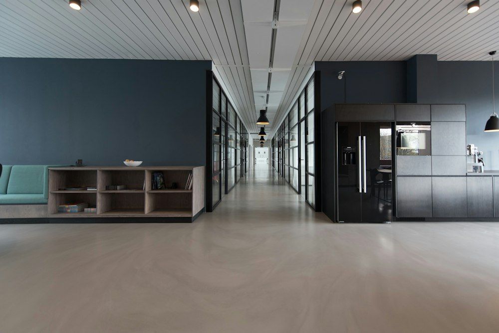 Modern office interior with a long glass-walled corridor
