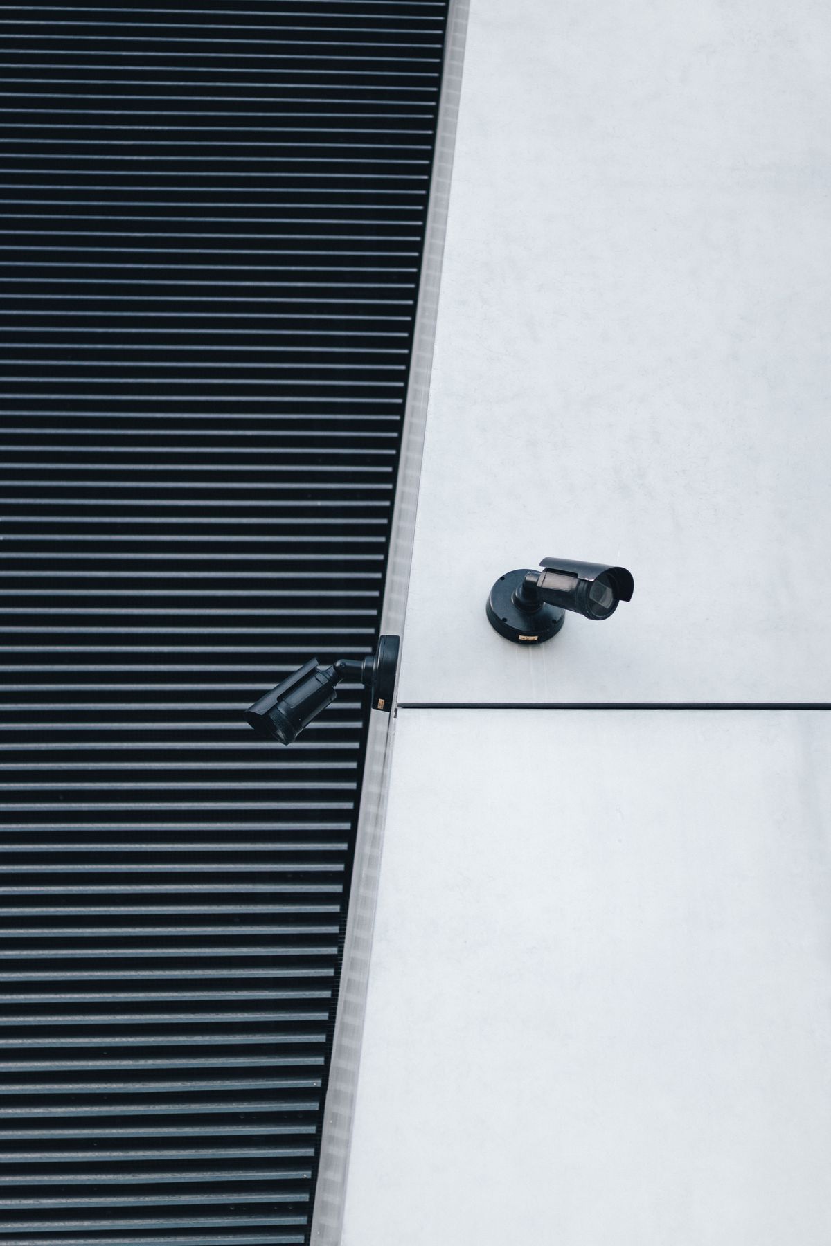 Two IP security cameras mounted on a building wall